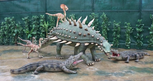 Dinosaurier Gastonia mit kleinen Raptors und Krokodilen