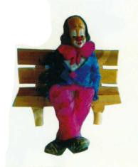 sitzender Clown klein auf Bank